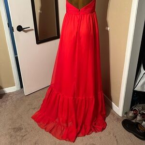 Beautiful red soft and flowy Mac Duggal gown with high neck.